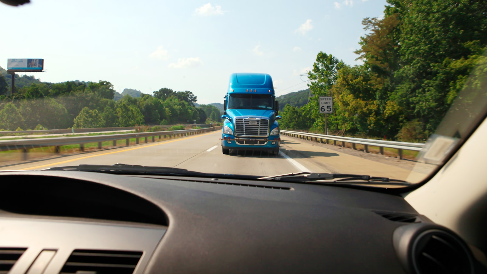 A commercial truck approaching on a highway, seen from a following car