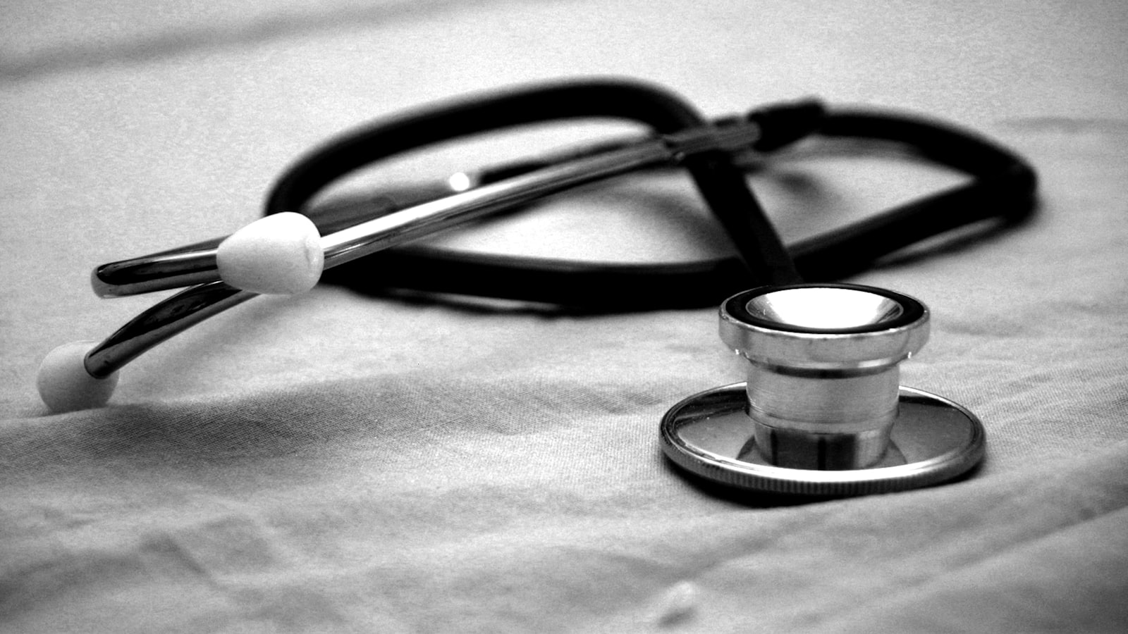 A stethoscope resting on a cloth surface