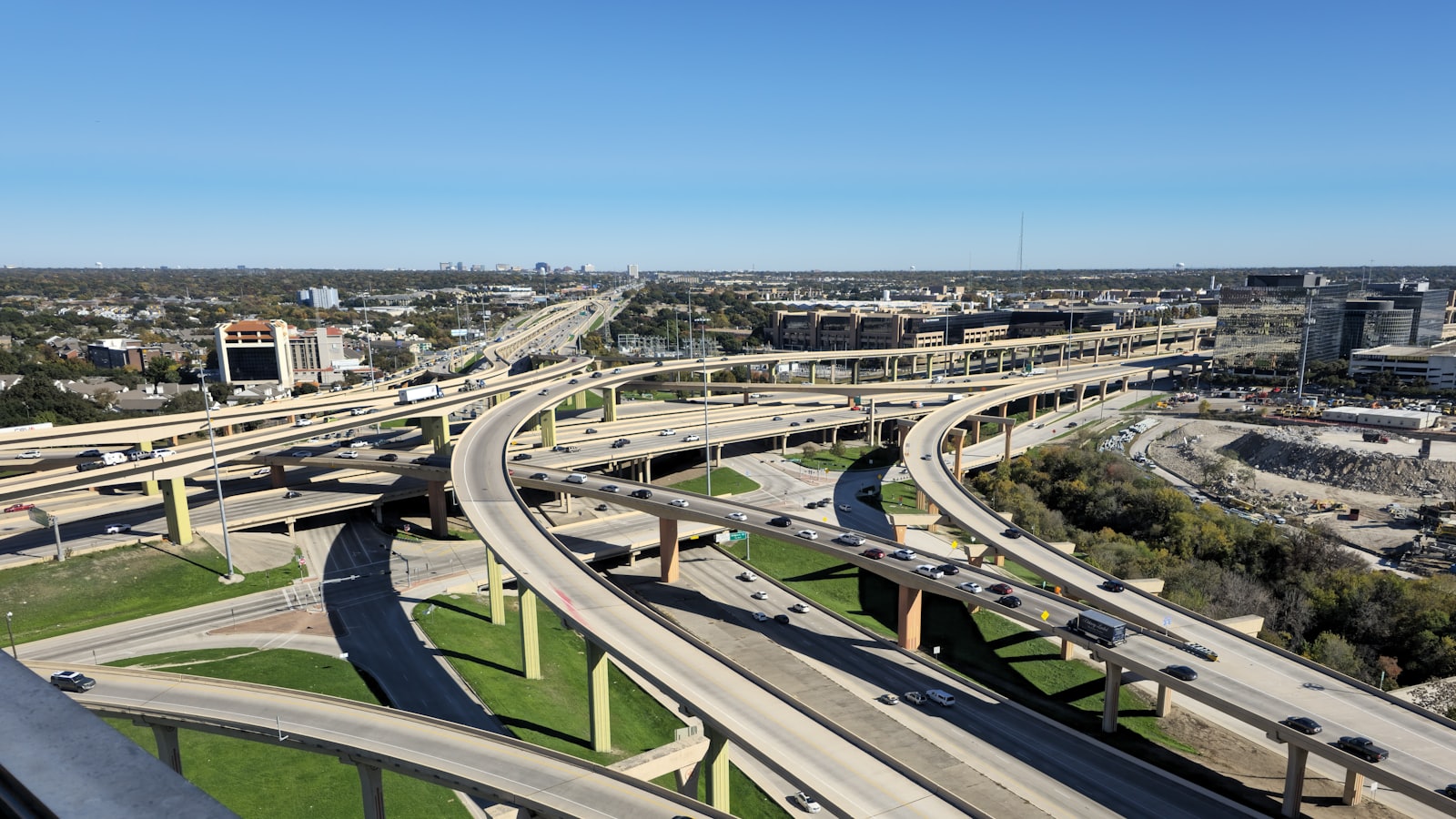 A multi-level urban highway interchange busy with traffic